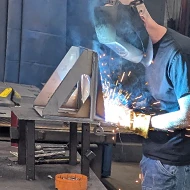 man welding with face shield