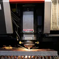 a laser cutting a metal fabrication part