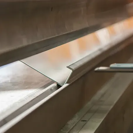 piece of metal being formed in a panel bender