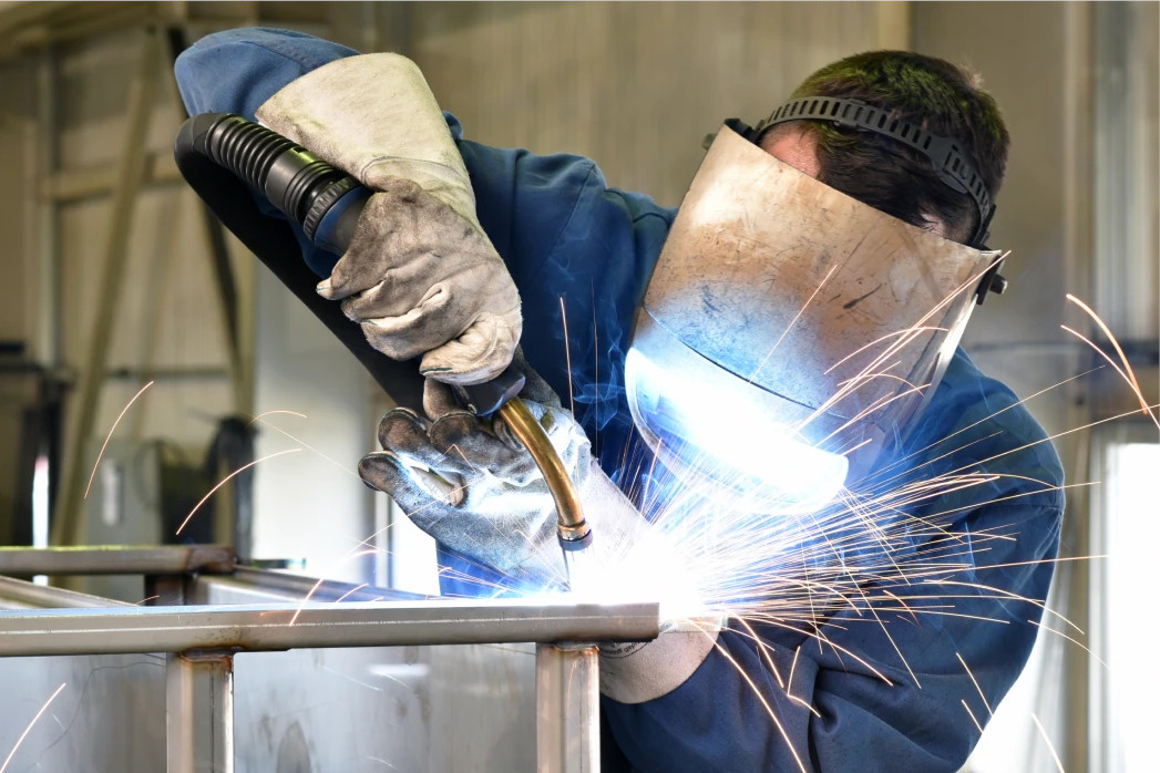 Technician welding a metal component