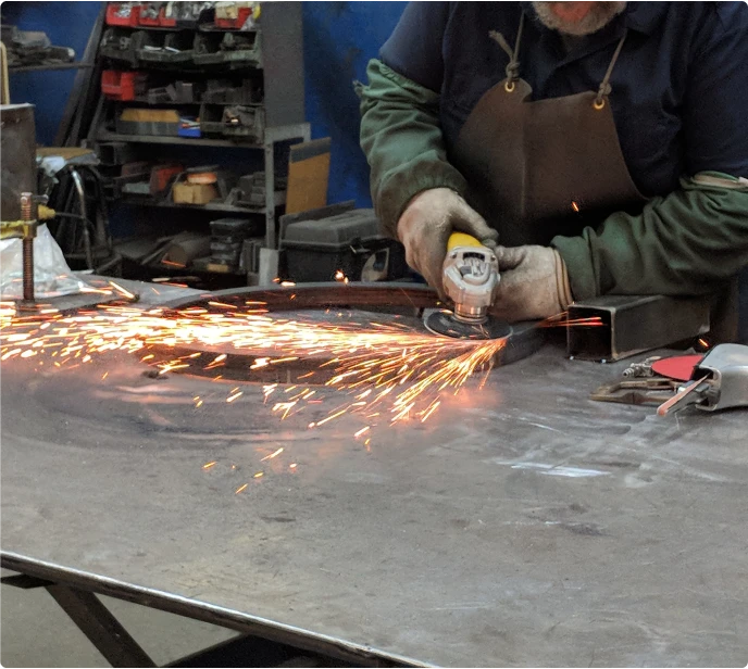 Grinding machine in use for metal finishing