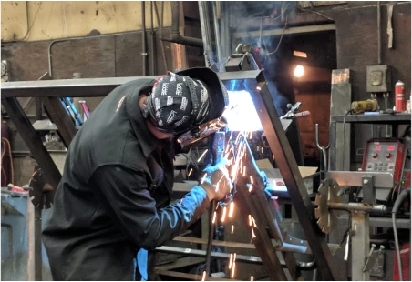 Technician welding a part