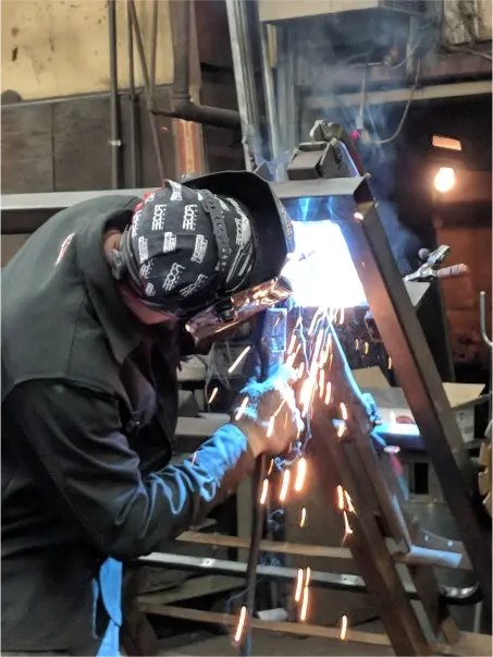 man welding a complex weld