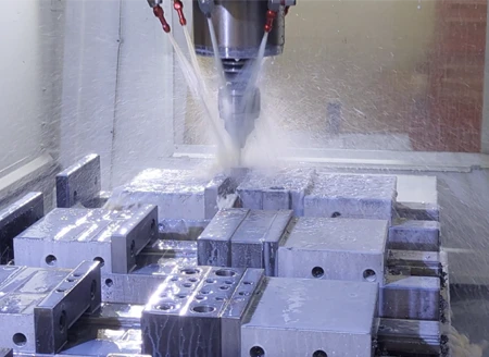 CNC machine cutting and shaping a metal component