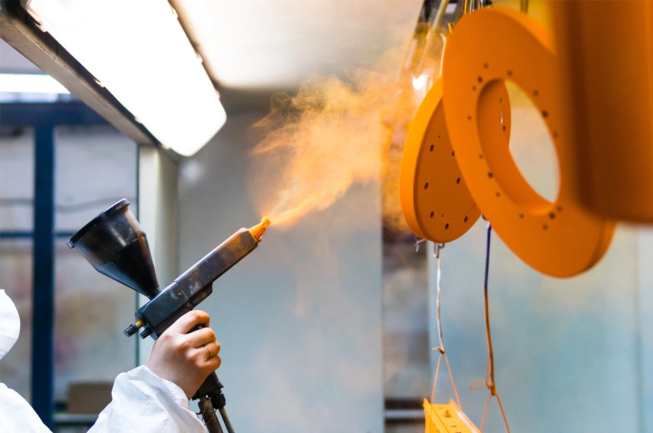 Powder coating and finishing on manufactured metal part
