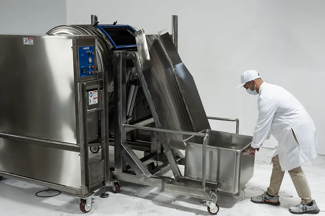 food processor pushing meat buggy up to buggy lift