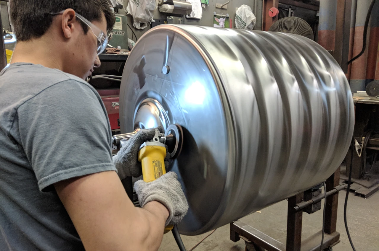 Technician checking quality of metal fabrication process