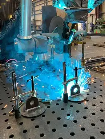 robotic welding in action - sparks flying in shop