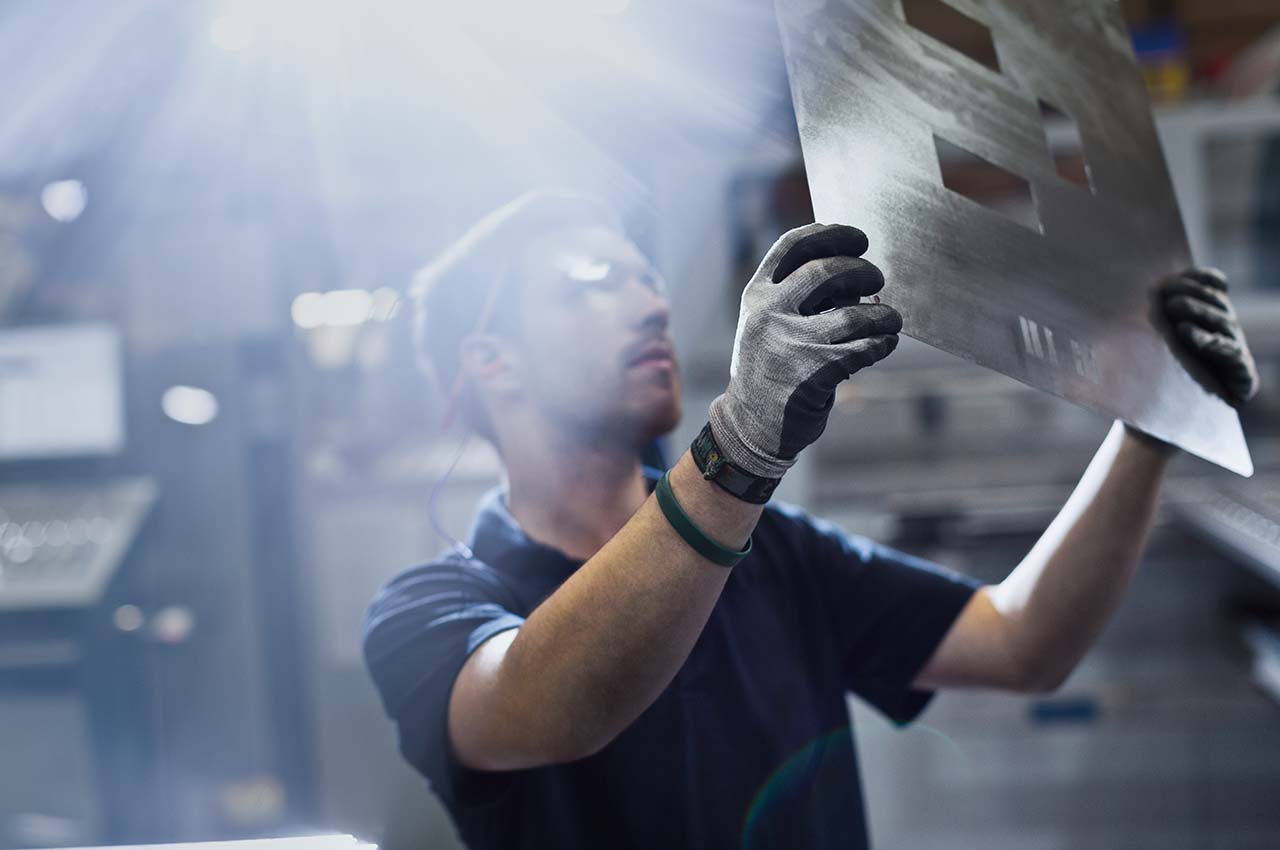 man holding sheet metal