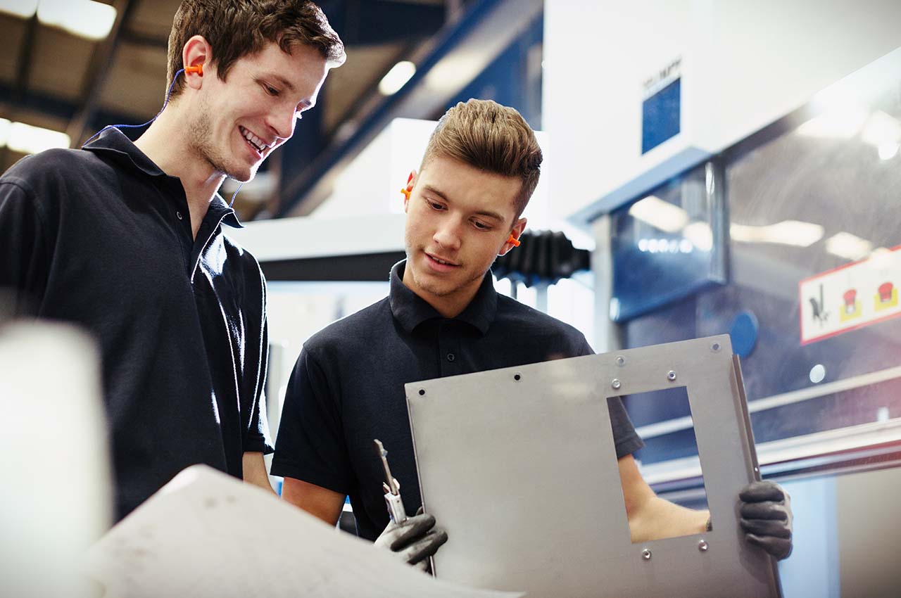 2 men looking at metal